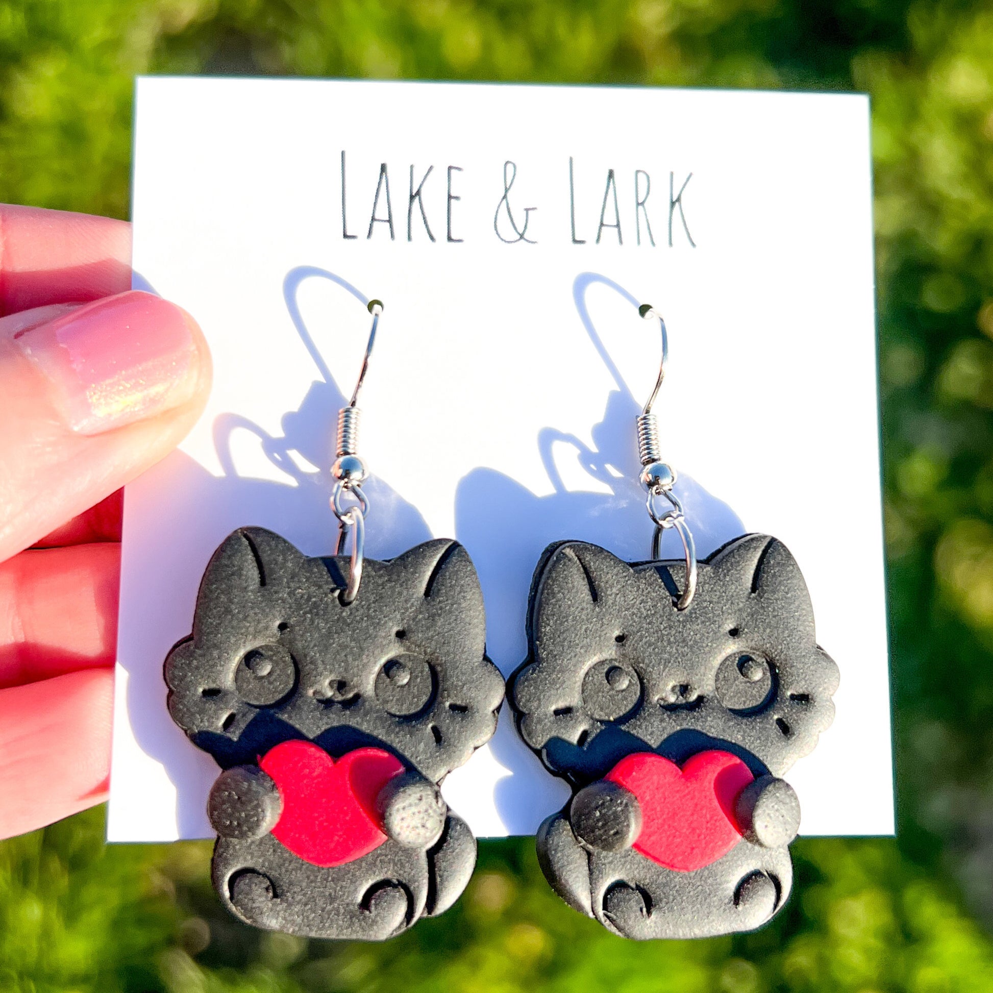 black cat holding heart valentine earrings